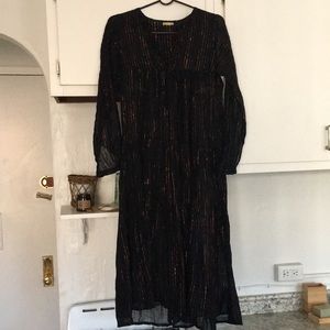 Matta XS metallic rainbow striped dress on a black backdrop.